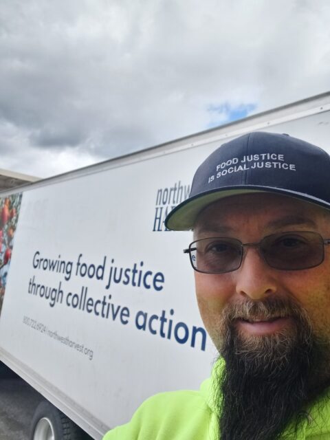 Danny Ellis taking a selfie in front of Northwest Harvest truck